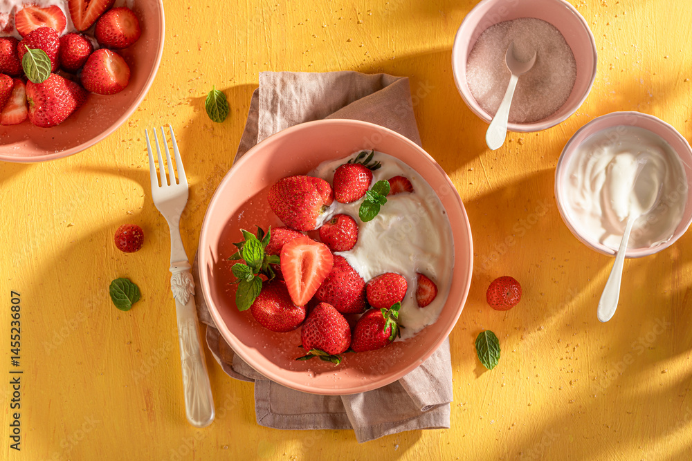 Creamy and delicious strawberries served in summer sunny day.