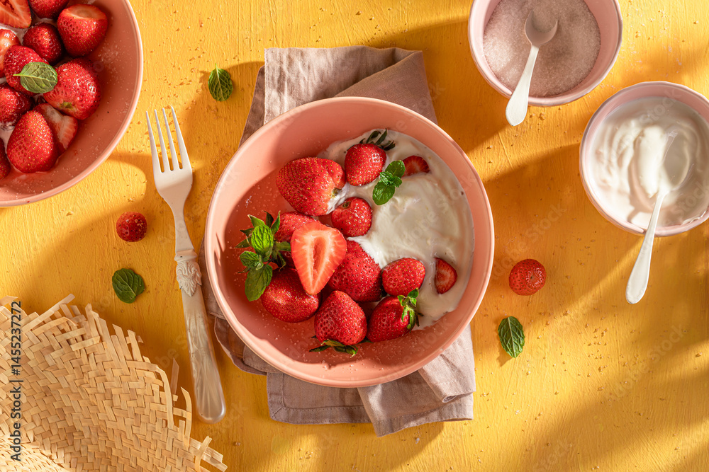 Tasty and creamy strawberries served in summer sunny day.