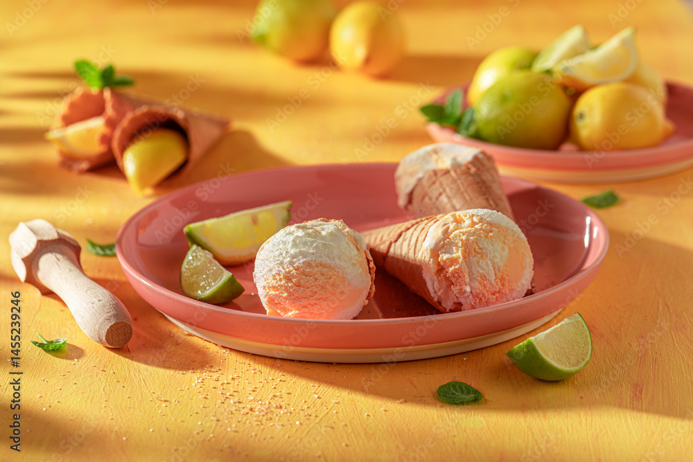 Homemade and juicy lemon ice cream in a waffle cone.