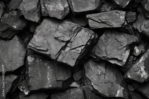 Coal texture background with irregular black shiny chunks in close view