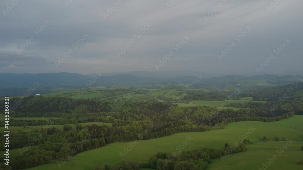 Dramatic evening view of the mountains near Králický Sněžník and Sviní hora, Czech Republic, just before a storm. Majestic landscape with dark clouds gathering above the peaks. Dramatic evening view of the mountains near Králický Sněžník and Sviní hora, Czech Republic, just before a storm. Majestic landscape with dark clouds gathering above the peaks.