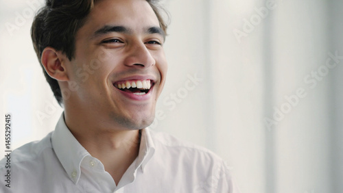 Joyful young man beams with a genuine smile, showcasing bright, healthy teeth with glee