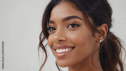 Smiling woman with dark hair in a softly lit close-up portrait