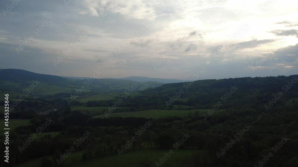 Dramatic evening view of the mountains near Králický Sněžník and Sviní hora, Czech Republic, just before a storm. Majestic landscape with dark clouds gathering above the peaks. Dramatic evening view of the mountains near Králický Sněžník and Sviní hora, Czech Republic, just before a storm. Majestic landscape with dark clouds gathering above the peaks.