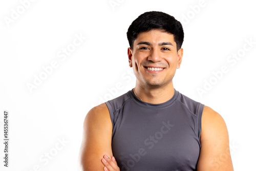 Young latin man smiles in a sporty tank top on a white background with copy space