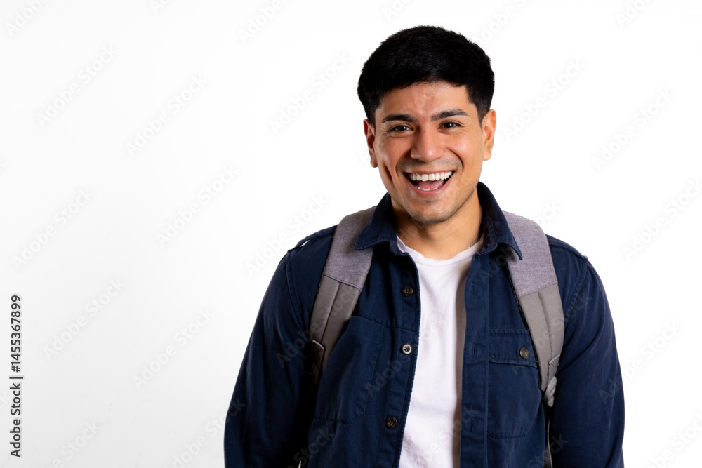 Young Latin man, carrying a backpack, looking at the camera, laughing with his mouth open in a white setting Young Latin man, carrying a backpack, looking at the camera, laughing with his mouth open in a white setting