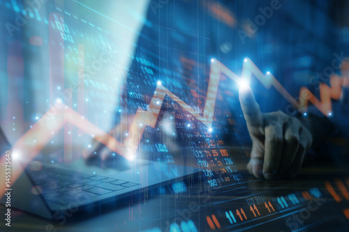Obraz na płótnie Businessman analyzing investment charts and financial data during periods of high market volatility to make informed decisions w salonie