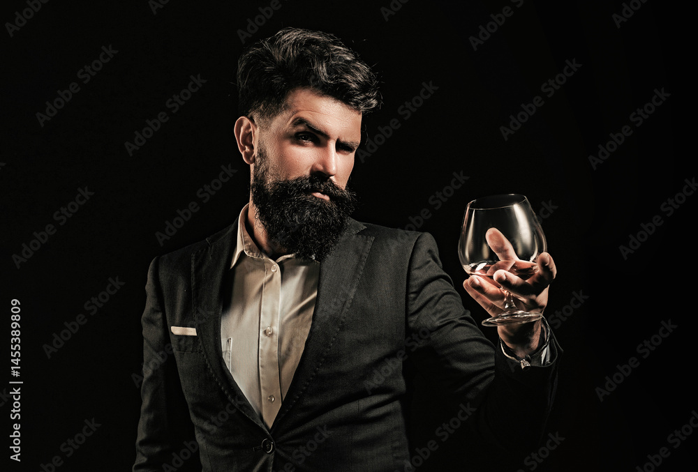 Whiskey glass held by bearded man. Guy drinking whiskey alone at bar. Whiskey pour in classic vintage glass. Whiskey tasting with retro style. Expensive whisky. Cognac or whisky. Alcoholic beverage.