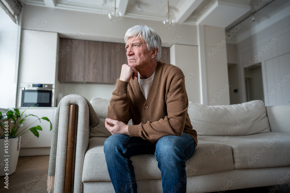 Sad sorrowful senior man sit in quiet contemplation supporting head with hand, looking through window at home. Late life depression, cognitive concerns, social withdrawal, memory worry, aging struggle Sad sorrowful senior man sit in quiet contemplation supporting head with hand, looking through window at home. Late life depression, cognitive concerns, social withdrawal, memory worry, aging struggle