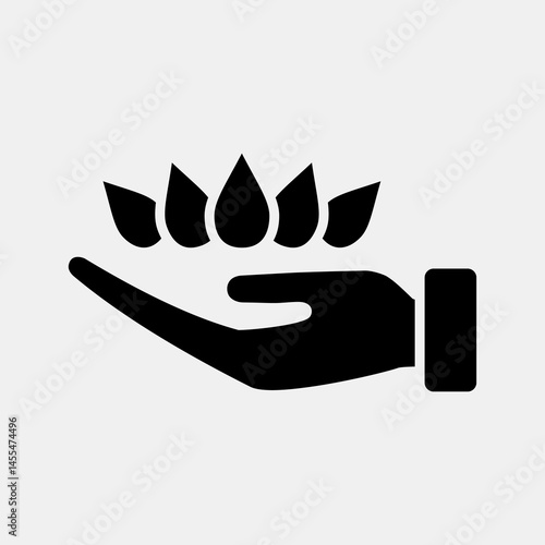 Icon lotus on hand. Buddhism and vesak elements. Icon in glyph style.