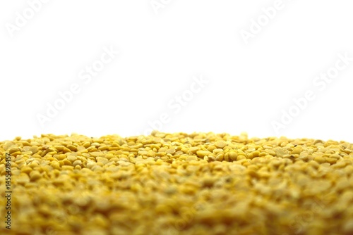 A lot of soybeans on a white background. The soybeans are tightly packed to cover the lower half of the image, giving it an even texture. Each soybean is small.