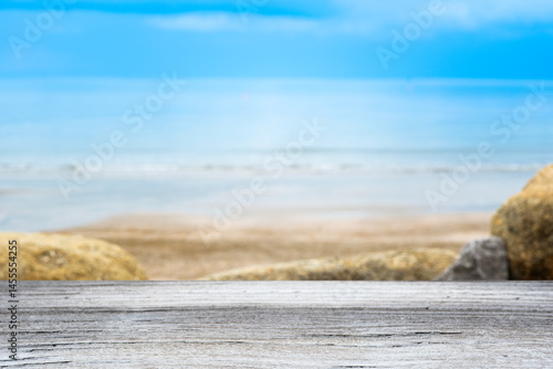 Wood floor counter top There is a view of sea in the background of the resort. A blurry beach and sky  is visible. of decorative design ideas