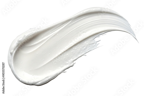 A creamy white swirl of lotion or moisturizer against a stark black background in a studio shot