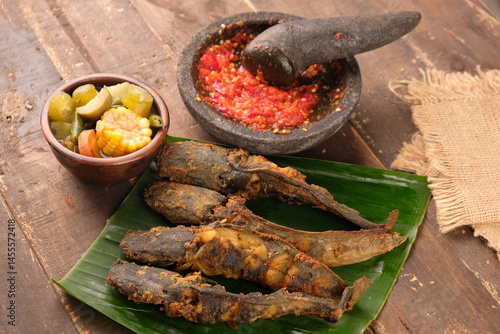 Pecel Lele, sambal, sayur Asem. fried catfish chili sauce, sour vegetables. Indonesian food.
