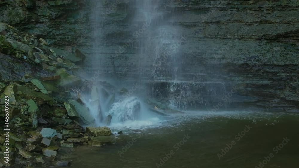 Water cascading down the Hamilton Waterfalls, creating mist and a serene natural scene Water cascading down the Hamilton Waterfalls, creating mist and a serene natural scene