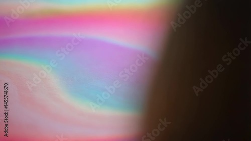 Abstract pastel swirls with iridescent rainbow hues and a shadowed corner