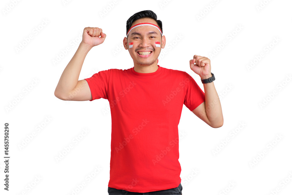 Fototapeta premium Excited young Asian man celebrating Indonesian independence day standing while raising fist isolated on transparent background