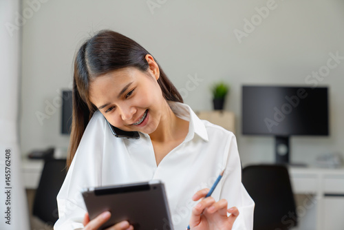 Young Asian businesswoman working talking to customers from order online and packing on the box.
