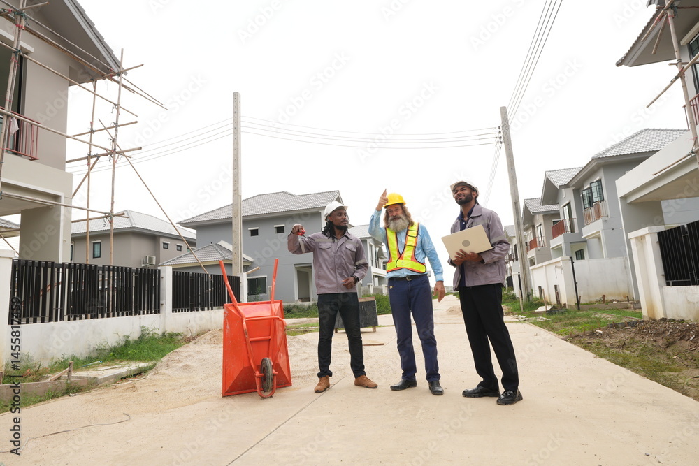 Two black foremen and a multi-ethnic Caucasian construction manager attend a construction inspection meeting and consult on construction inspections on a construction project.