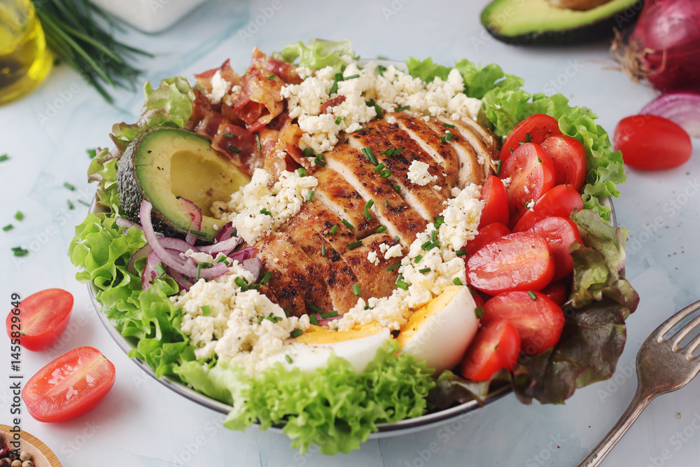 A bowl with cobb salad, traditional American dish