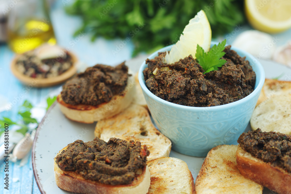 A bowl with tapenade - traditional olive dip in Mediterranean region