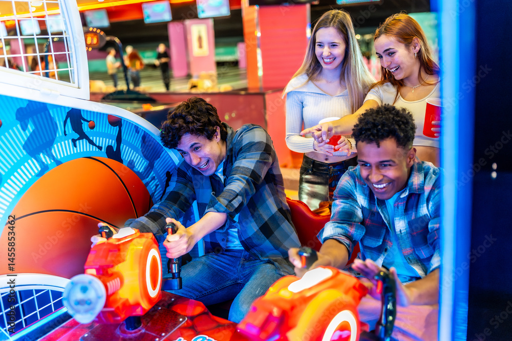 Friends playing arcade basketball game together in bowling alley