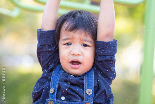 Obraz na płótnie Adorable little asian 2 - 3 year boy climbing practice in playground outdoor w salonie