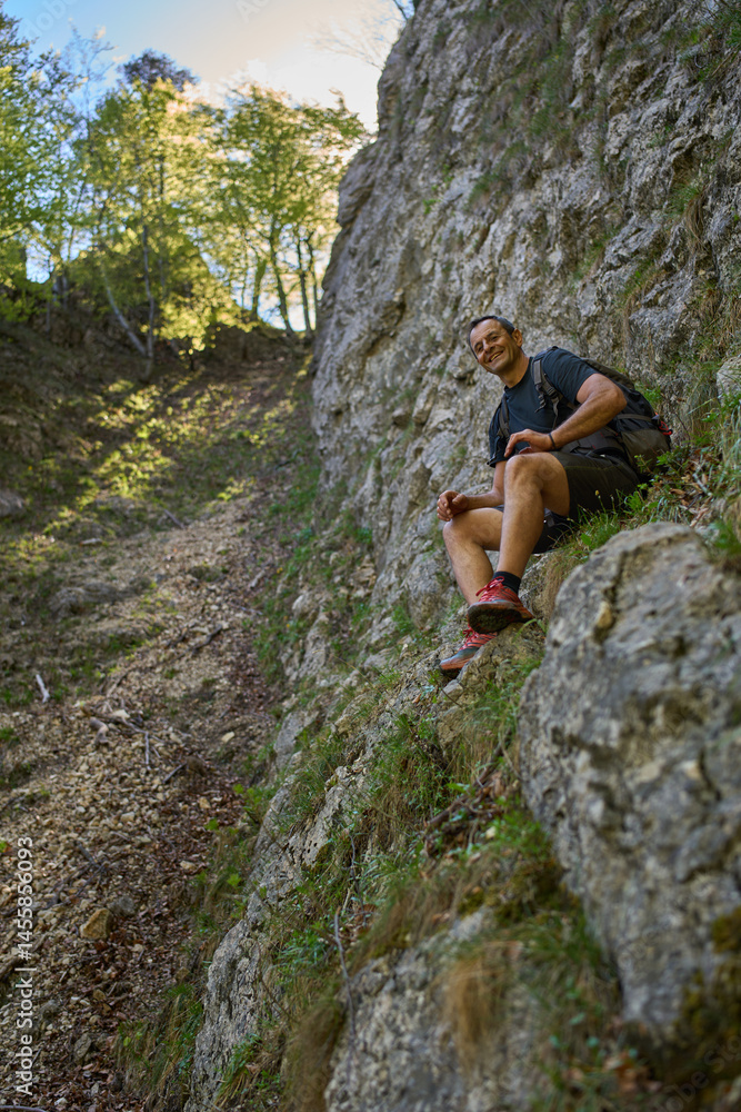 Man resting on rocky ledge Man resting on rocky ledge