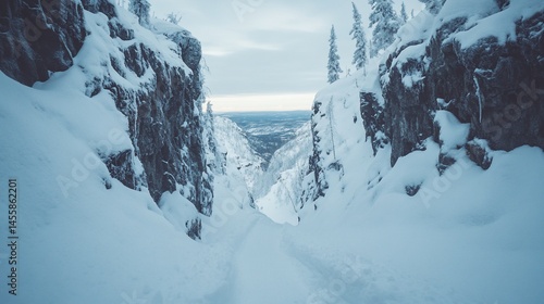 Snow-covered mountain pass with a valley view