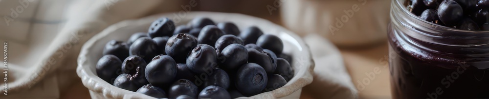 A bowl of fresh blueberries beside a jar of homemade blueberry jam , blueberries, food A bowl of fresh blueberries beside a jar of homemade blueberry jam , blueberries, food