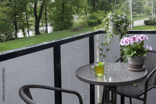 Obraz na płótnie cup of green tea on balcony in rain w salonie