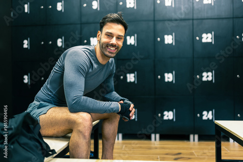 Εκτύπωση καμβά Fit handsome man gets ready to workout in the dressing room of the gym