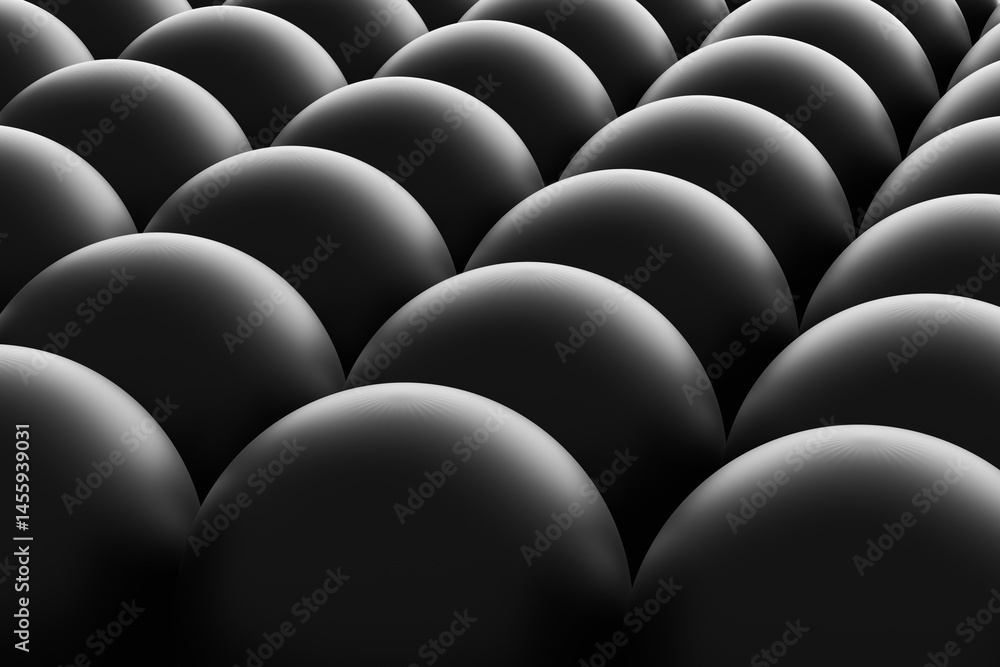 Fototapeta premium Dark spheres forming a uniform pattern creating a mesmerizing texture