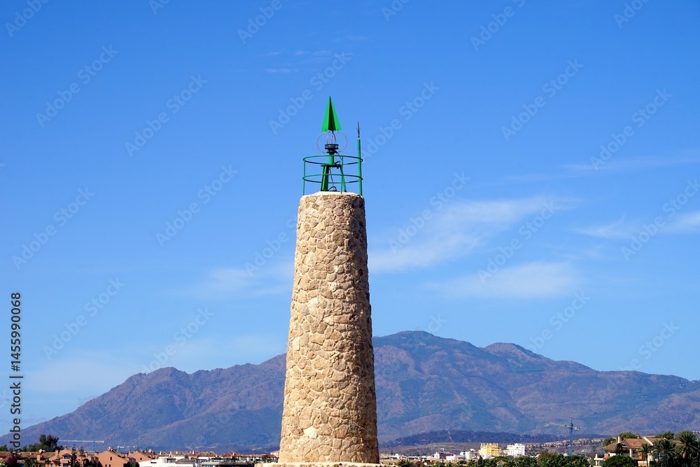 Obraz premium Faro Puerto Banús lighthouse at the famous habor Puerto Banús with luxury yachts, Marbella, Malaga, Costa del Sol, Spain