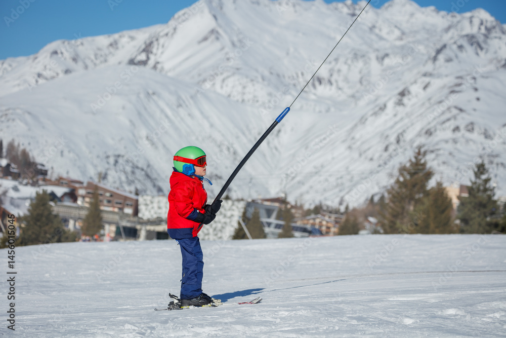 Young skier rids the slopes with vibrant gear and stunning views