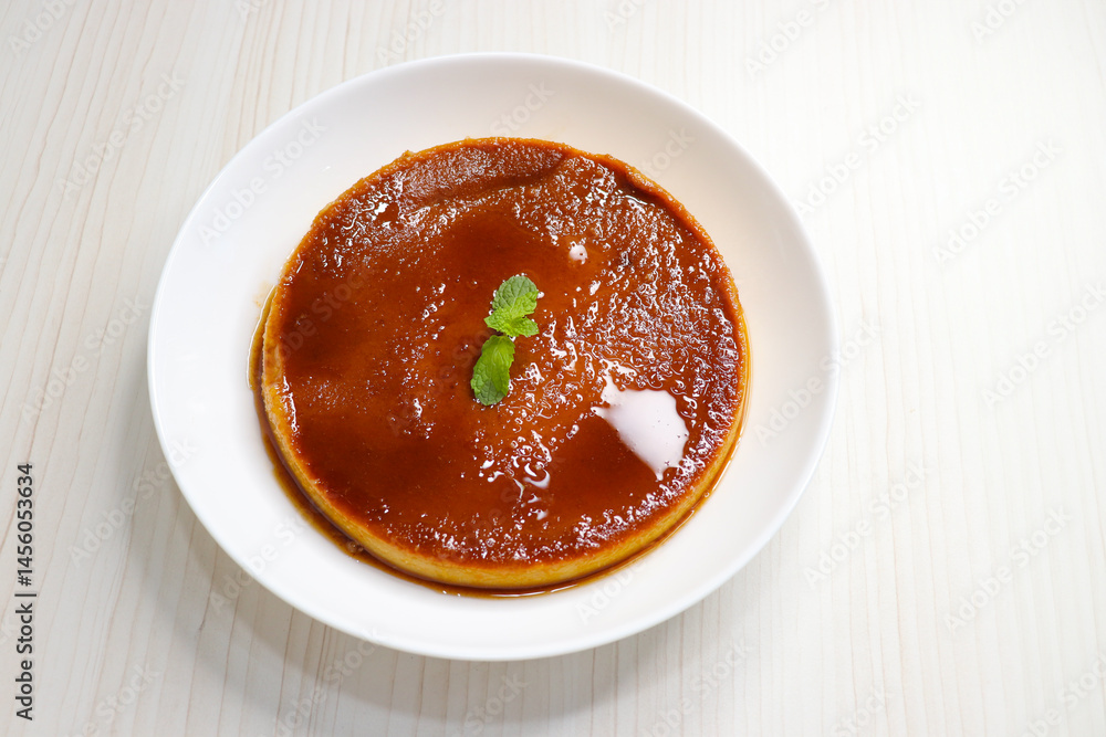 Delicious caramel custard with a glossy caramel top, served on a white plate. Perfectly lit, smooth texture, and minimal background. ideal for menus, blogs, packaging, or dessert features. Copy space Delicious caramel custard with a glossy caramel top, served on a white plate. Perfectly lit, smooth texture, and minimal background. ideal for menus, blogs, packaging, or dessert features. Copy space