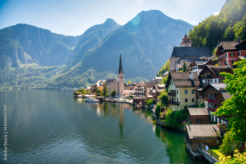 Fototapeta premium Picturesque view of Hallstatt city and lake, surrounded by stunning alpine mountains and serene waters