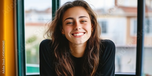 Obraz na płótnie Young caucasian female smiling indoors with natural light from window w salonie