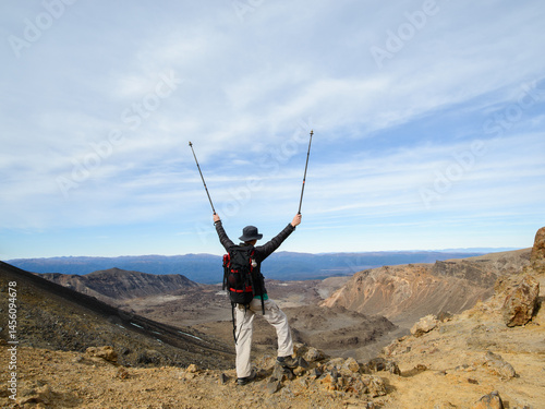 Obraz na płótnie Man with arms raised at Tongariro Alpine crossing, Tongariro National Park. New Zealand. w salonie