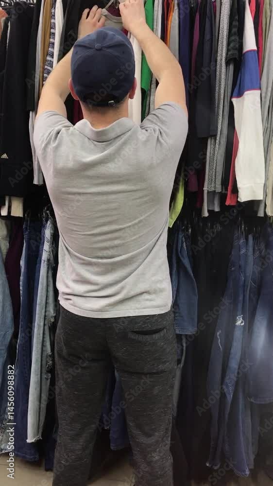 Shopping for clothes in a busy thrift store Shopping for clothes in a busy thrift store