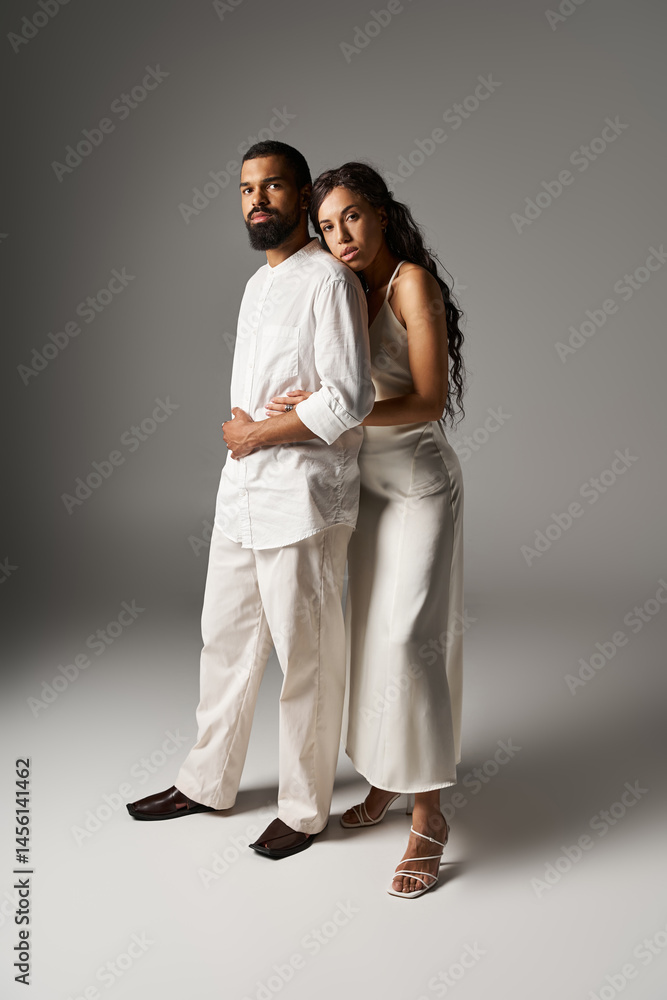 Stylish couple embraces in a modern studio, showcasing love and fashion elegance Stylish couple embraces in a modern studio, showcasing love and fashion elegance