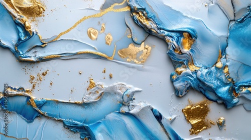 Abstract fluid painting in shades of icy blue and dusty white with gold flecks flowing across