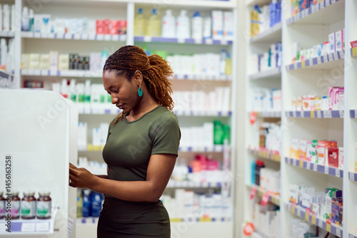 Focused Woman Shopping for Medical Products in a Local Pharmacy Store