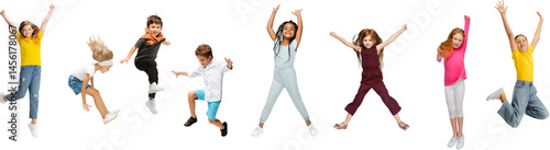 Obraz na płótnie Group of kids in casual clothing jumping with expressive faces, showing joy isolated on transparent background. Concept of childhood, fun, leisure, friendship, early development. Banner w salonie