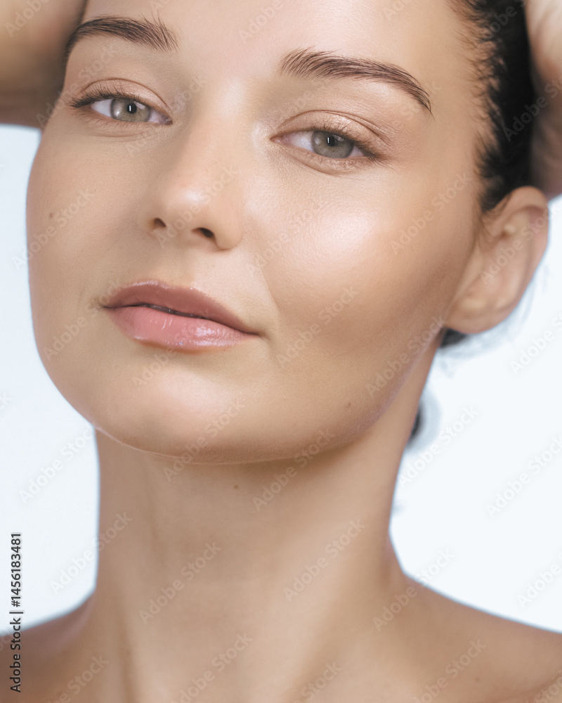 Close-up portrait of a young Caucasian woman with healthy glowing skin, minimal makeup, and a natural beauty look. Ideal for skincare, clean beauty, and wellness promotional content.