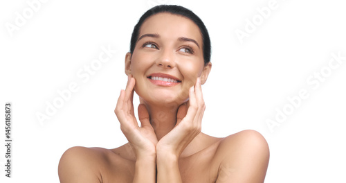 Obraz na płótnie Young Caucasian woman with flawless, glowing skin smiling joyfully while touching her face. Ideal for skincare, beauty, and wellness concepts in advertisements and promotions. w salonie