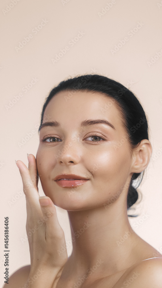 Caucasian woman with natural makeup and glowing complexion applying skincare product, perfect for beauty, health, wellness, or cosmetic product advertisement and promotional content.
