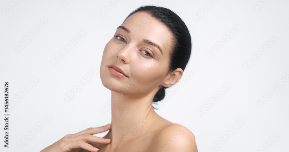 High-quality studio portrait of a graceful young woman with glowing skin and bare shoulders. Ideal for wellness, skincare advertising, beauty banners, and elegant promotional content.