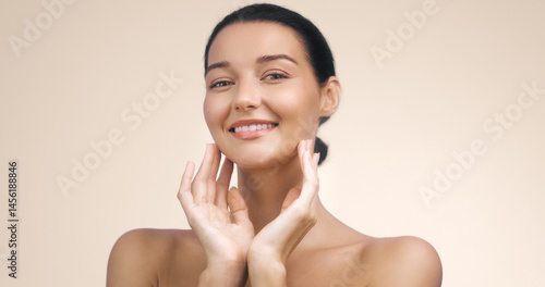 Obraz na płótnie Studio portrait of a young Caucasian woman smiling with radiant skin and a fresh, natural look. Ideal for beauty campaigns, skincare branding, and wellness lifestyle advertisements. w salonie