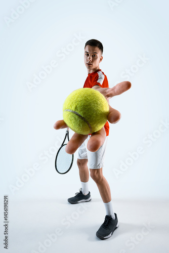 Full-length of man, tennis player shows ball before serve, demonstrating focus and control against white studio background. Concept of sport, game, tournament, practice, youth